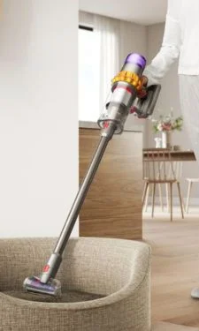 Vacuum cleaning up debris on the floor going across two different floor types