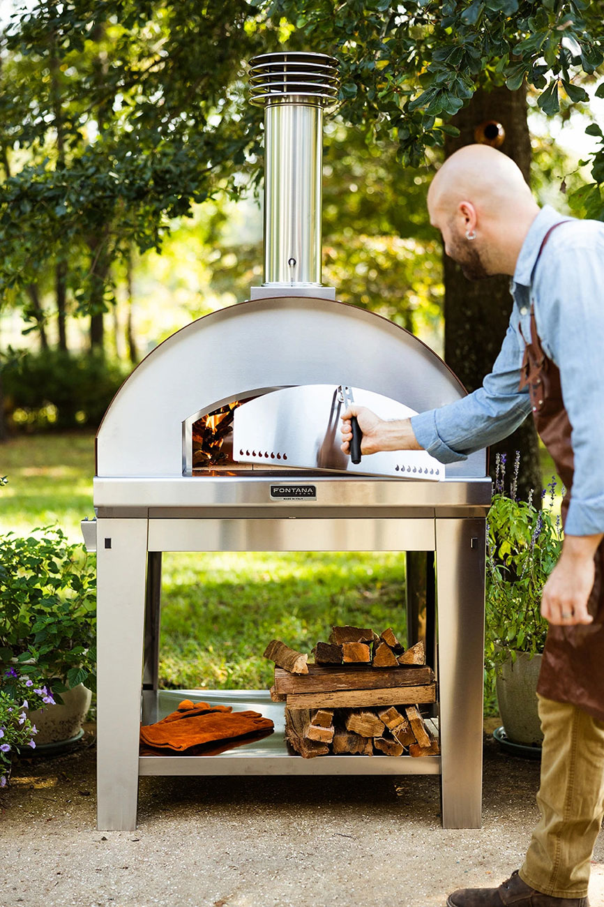 Feature View of Man Opening Pizza Oven