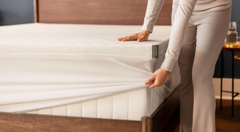 lifestyle image of a bed with a cover