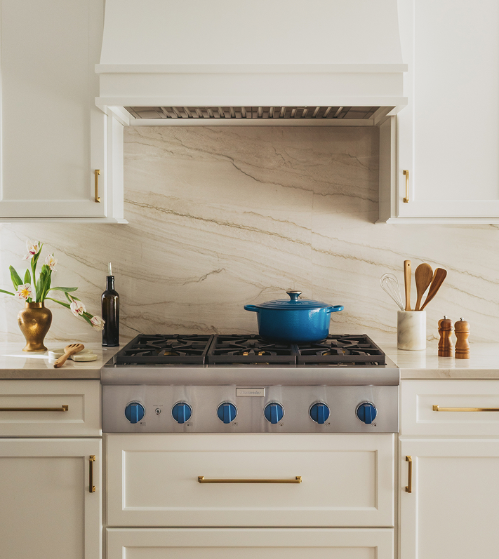 Aerial view of a Thermador cooktop with a variety of dishes cooking, highlighting a vibrant kitchen environment and premium appliance features