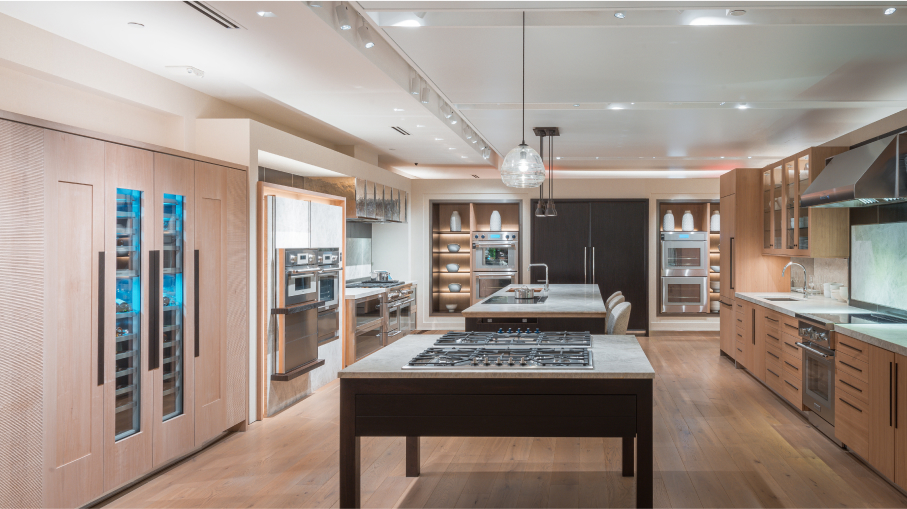 A stylish kitchen in a Thermador showroom, highlighting a high-end stove alongside a beautifully designed sink area