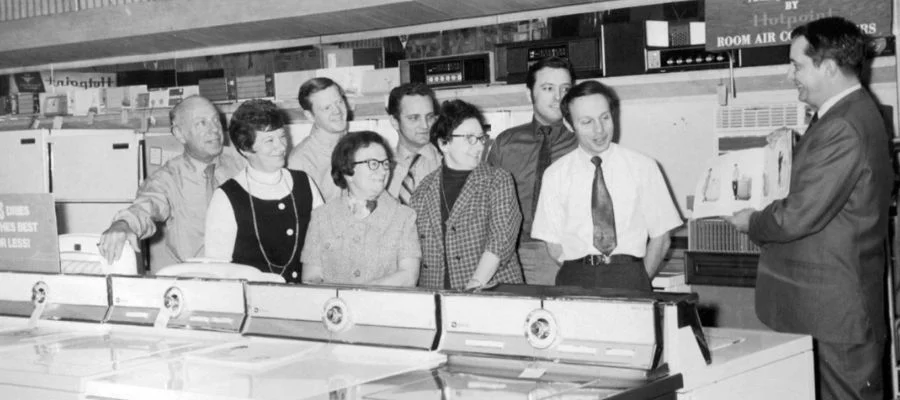 A black and white photograph of Abt employees from generations ago learning about appliances