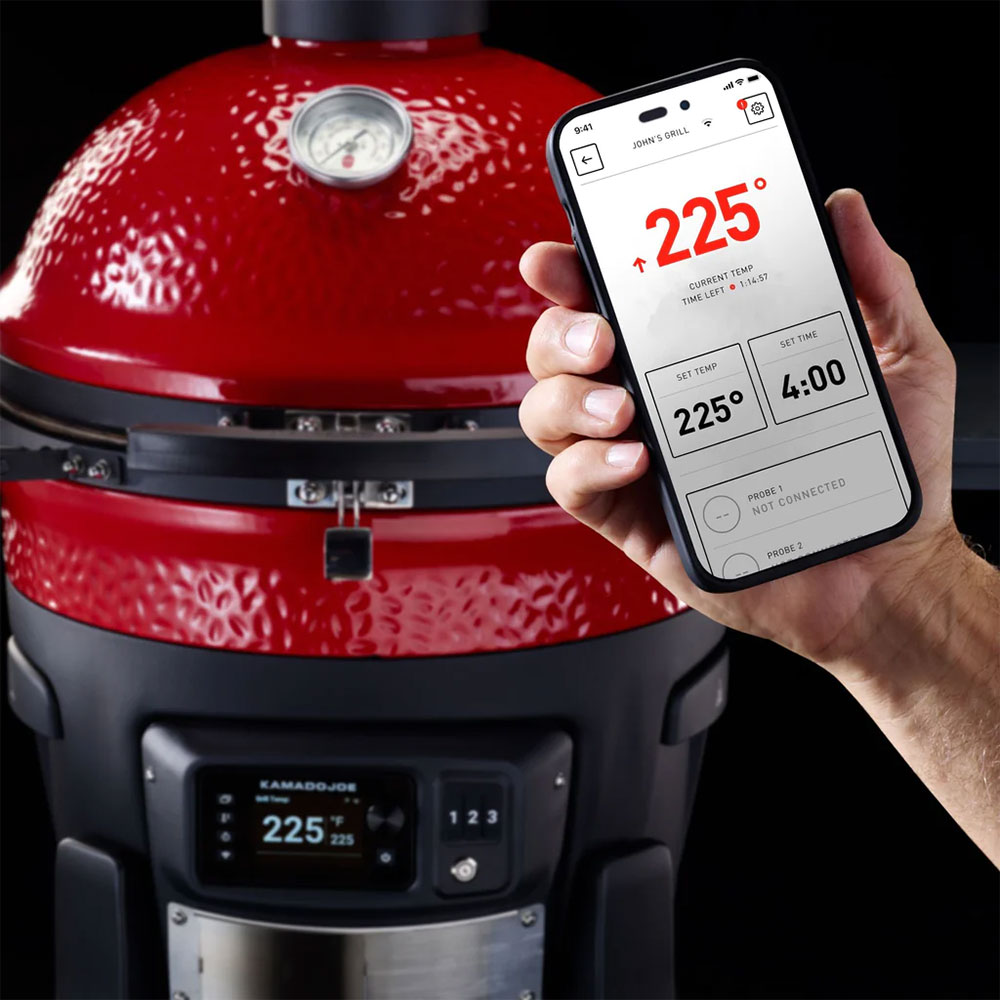 Person Using a Smart Phone to Control Settings on a Kamado Joe Charcoal Smoker and Grill