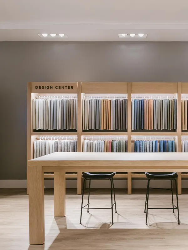 Tight shot on a bedroom side table with a lamp, books, and wilting flowers showcasing the decor options