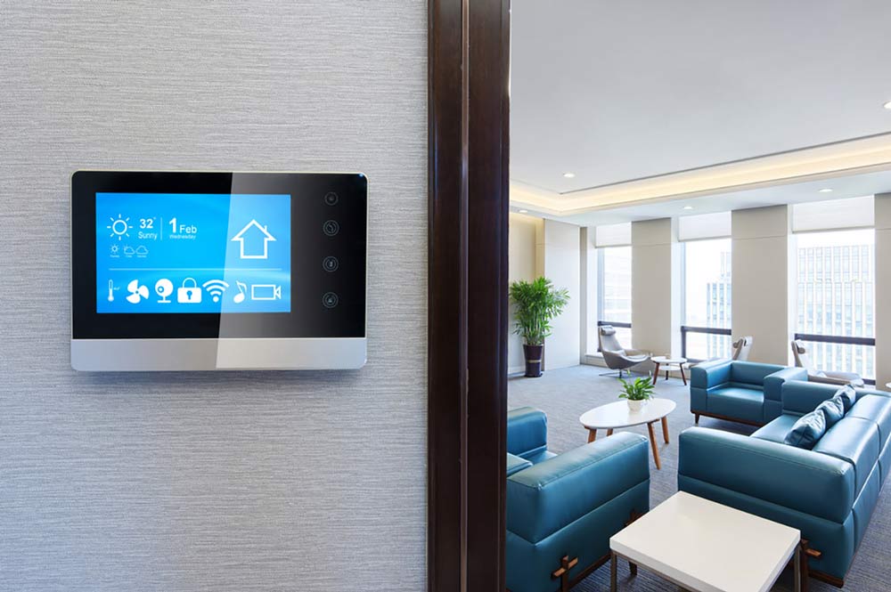 Digital thermostat in front of a room with furniture
