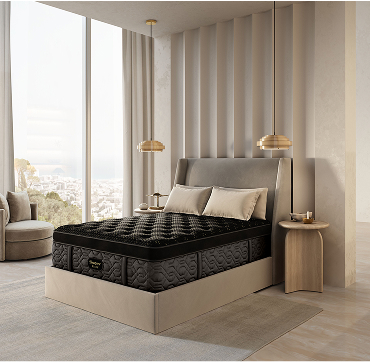 A modern bedroom featuring a neatly made beautyrest bed and a large window allowing natural light to enter the space