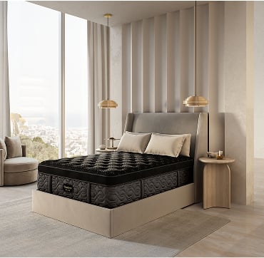 A modern bedroom featuring a neatly made beautyrest bed and a large window allowing natural light to enter the space