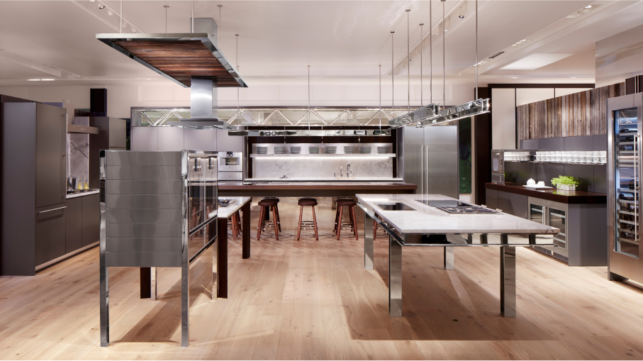 A Gaggenau retail showroom that displays a sophisticated kitchen design, highlighting a large island and an elegant refrigerator