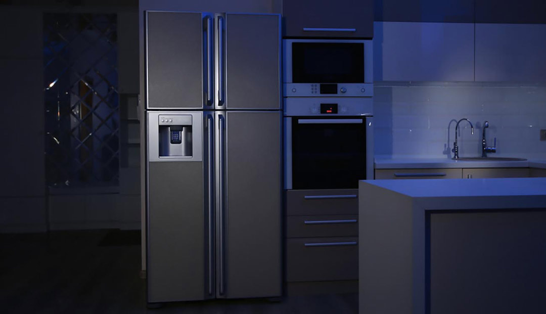 Kitchen with lights not on with a refrigerator