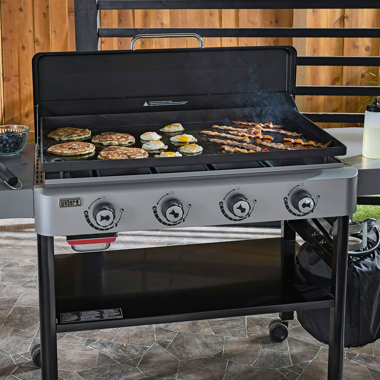 Wide view of Weber Liquid Propane Griddle outside cooking breakfast food