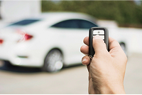 Person using remote start key fob to start parked vehicle