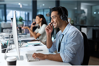 Support agent in headset providing 24/7 home security monitoring and emergency response