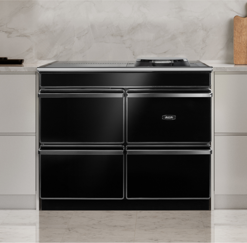 A modern kitchen featuring a black Aga Era range, complemented by sleek black and white accents throughout the design.