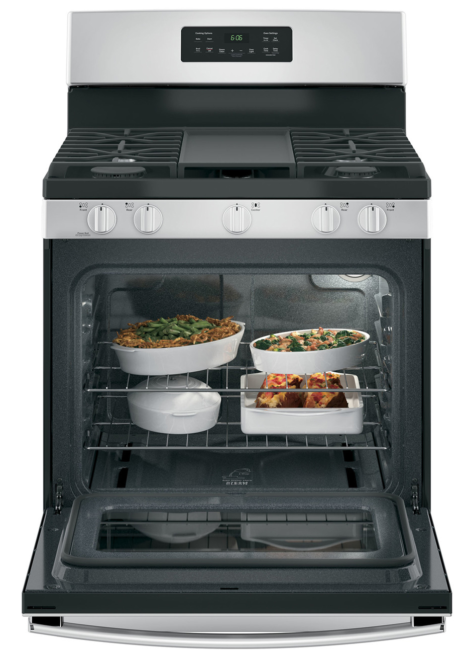 Open oven door with food cooking inside.
