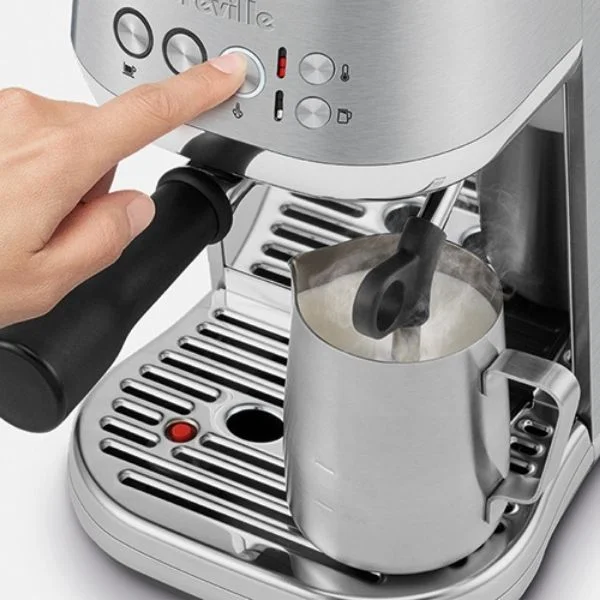 Birds-eye view of person making steamed milk on Bambino Plus.