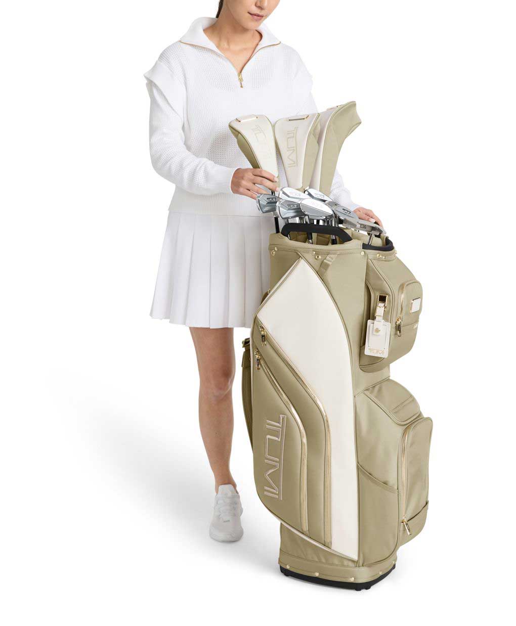 View of TUMI off white and tan golf bag1 with woman
