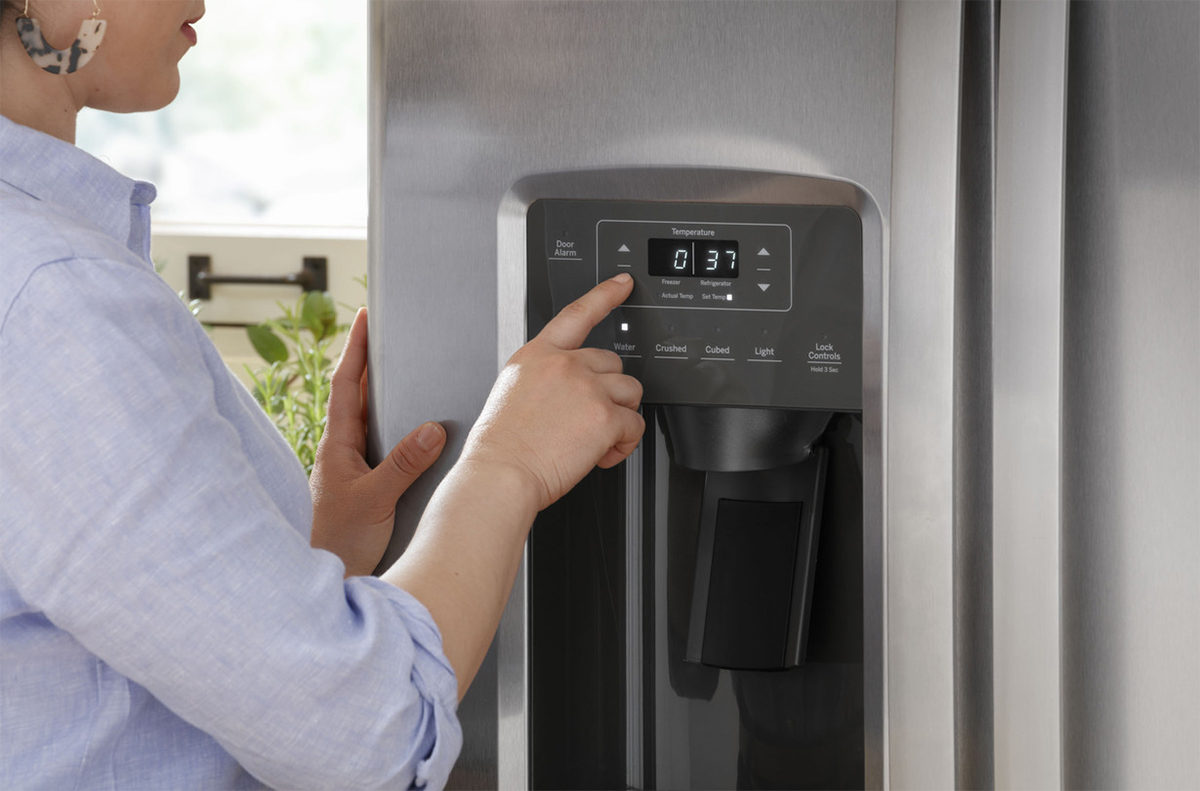 Angled view of person pressing button on dispenser