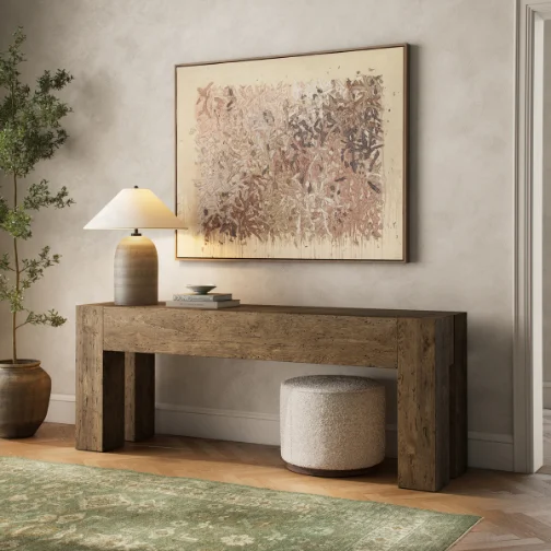 A wooden dresser featuring a decorative vase and a framed picture on top