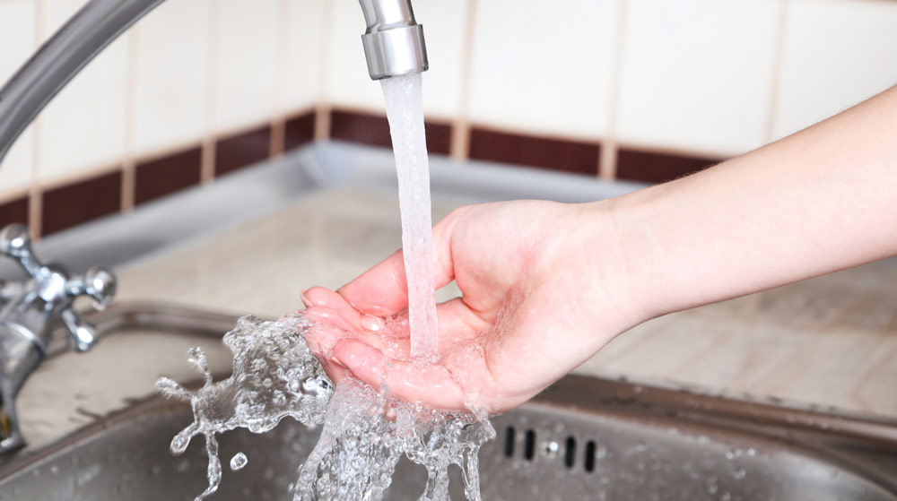 hand under faucet