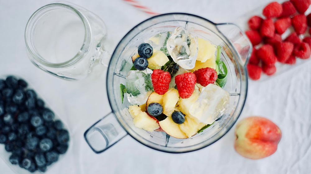 Overhead view of fruit in a glass bowl with ice