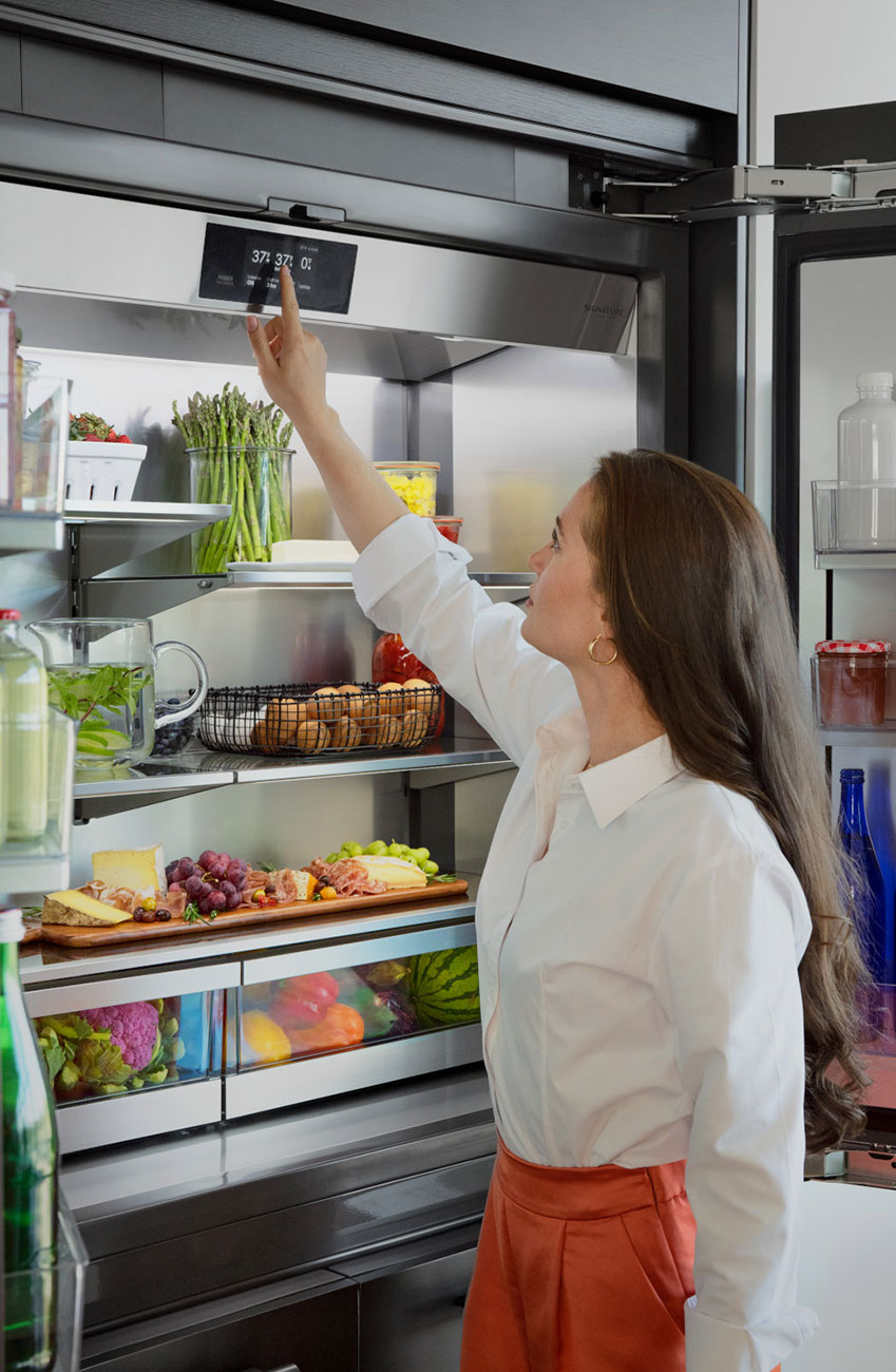 View of SKS Refrigerator Open with Woman