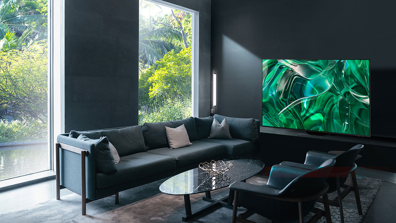 Living Room with Black Leather Couches, Chairs, and a Samsung 77 Inch 4K OLED TV
