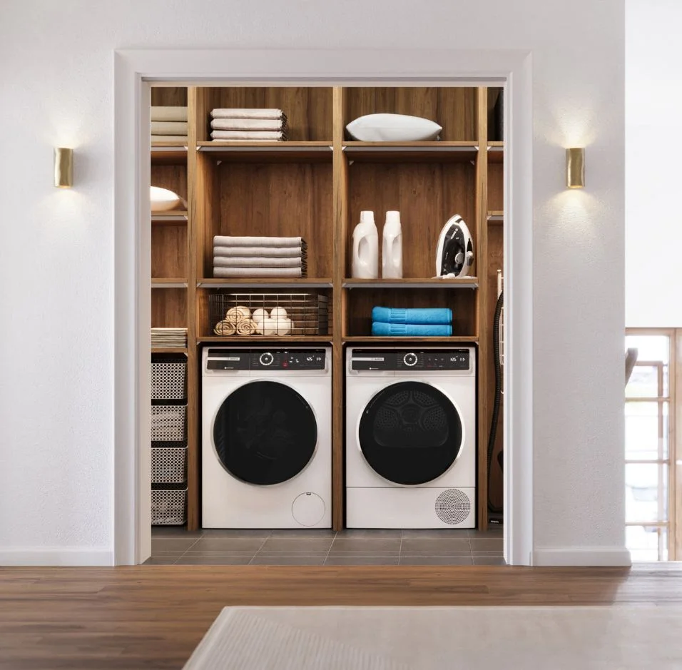 Elegant kitchen featuring white cabinetry, a sleek black sink, and premium Thermador Masterpiece Collection appliances, including a stove, refrigerator, and dishwasher