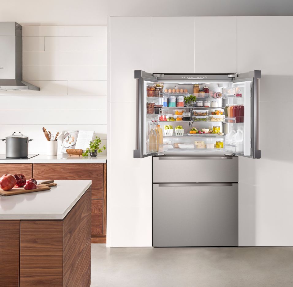 Elegant kitchen featuring white cabinetry, a sleek black sink, and premium Thermador Masterpiece Collection appliances, including a stove, refrigerator, and dishwasher