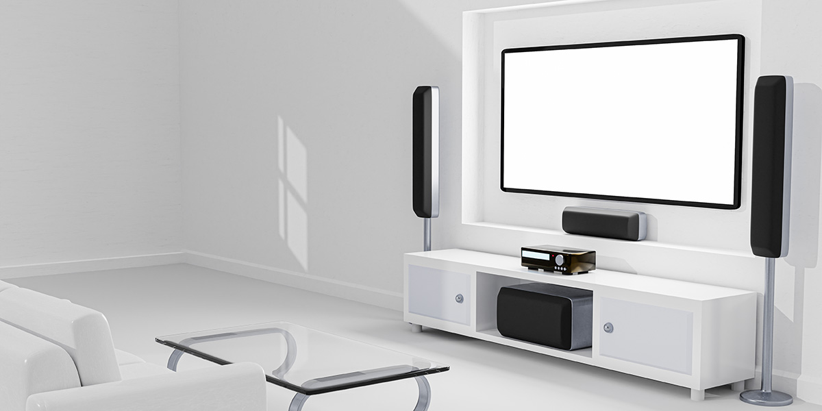 Wall mounted TV with soundbar and speakers in white room