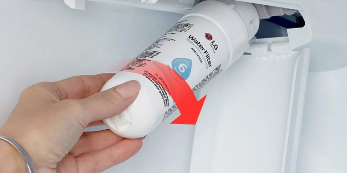Person replacing the water filter in their LG refrigerator.