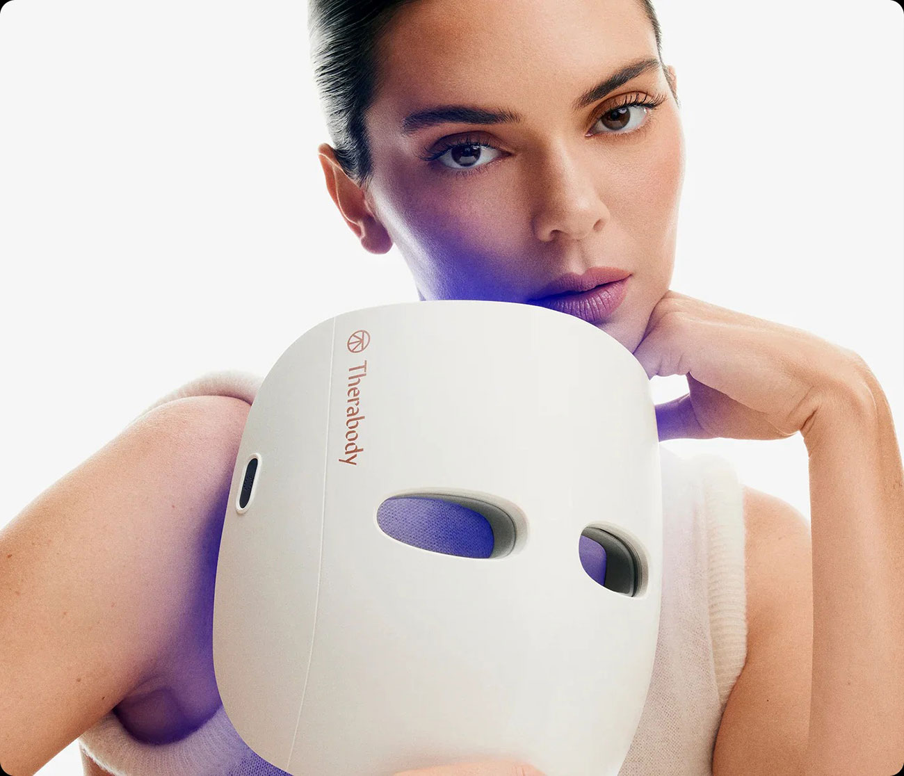 Woman Holding the Therabody Therapy Mask While Standing