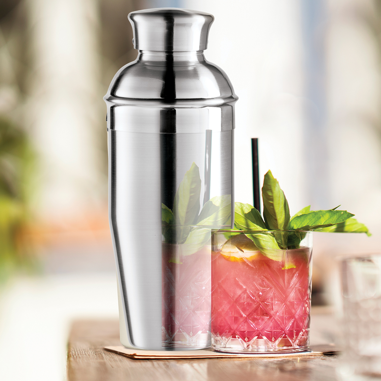 Lifestyle View of Oggi Cocktail Shaker Next To A Pink Drink