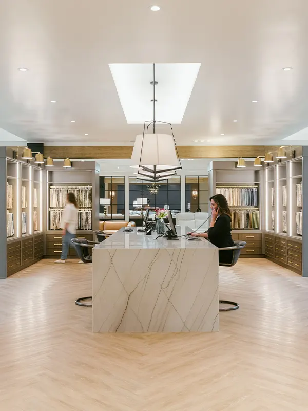 Wide shot of a modern living room with cream accents and furntiure neatly placed showcasing an organized and nicely decorated living room