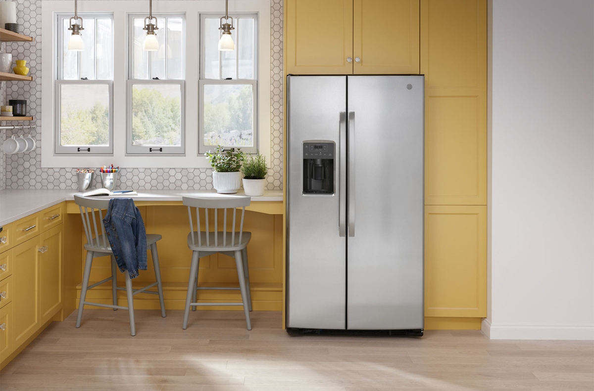 Front view of fridge installed in yellow kitchen
