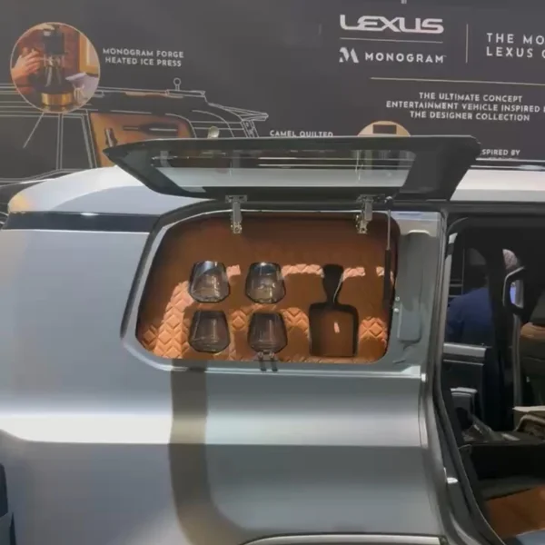 The exterior side panel of the Monogram GX lifted up to show the built-in wine and bourbon storage.