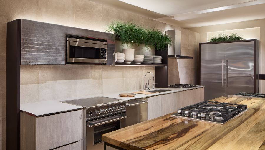 A Gaggenau retail showroom that displays a sophisticated kitchen design, highlighting a large island and an elegant refrigerator