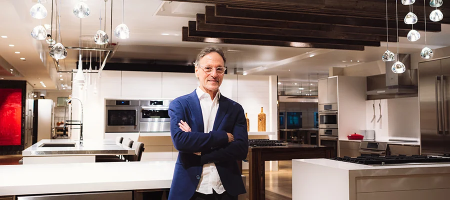 Mick De Giulio standing in the middle of one of the luxury kitchens featured in Abt's Inspiration Studio
