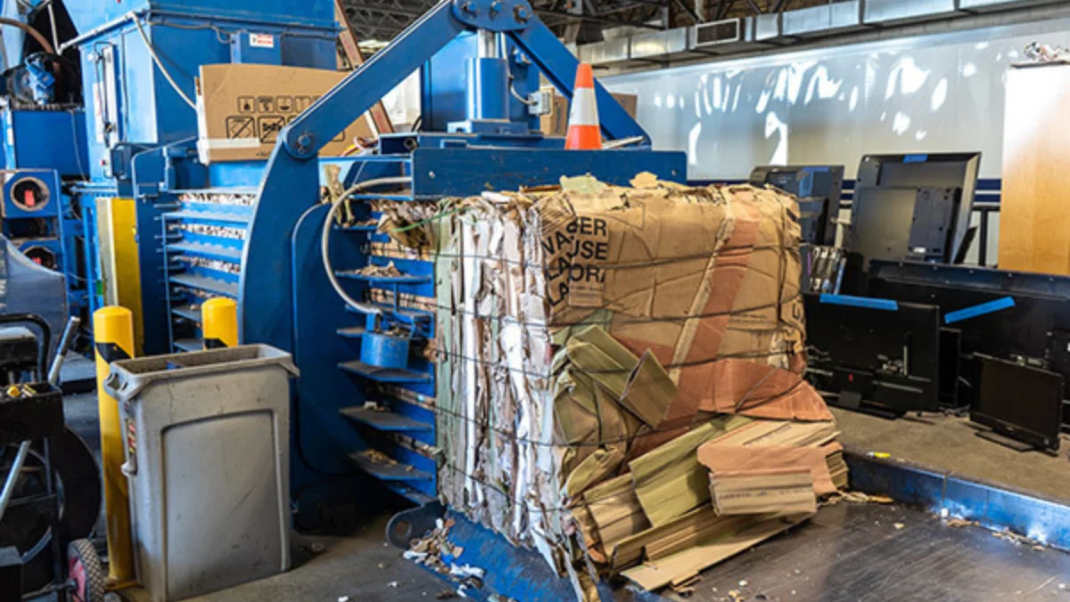 Inside of Abt recycling center compacting cardboard.