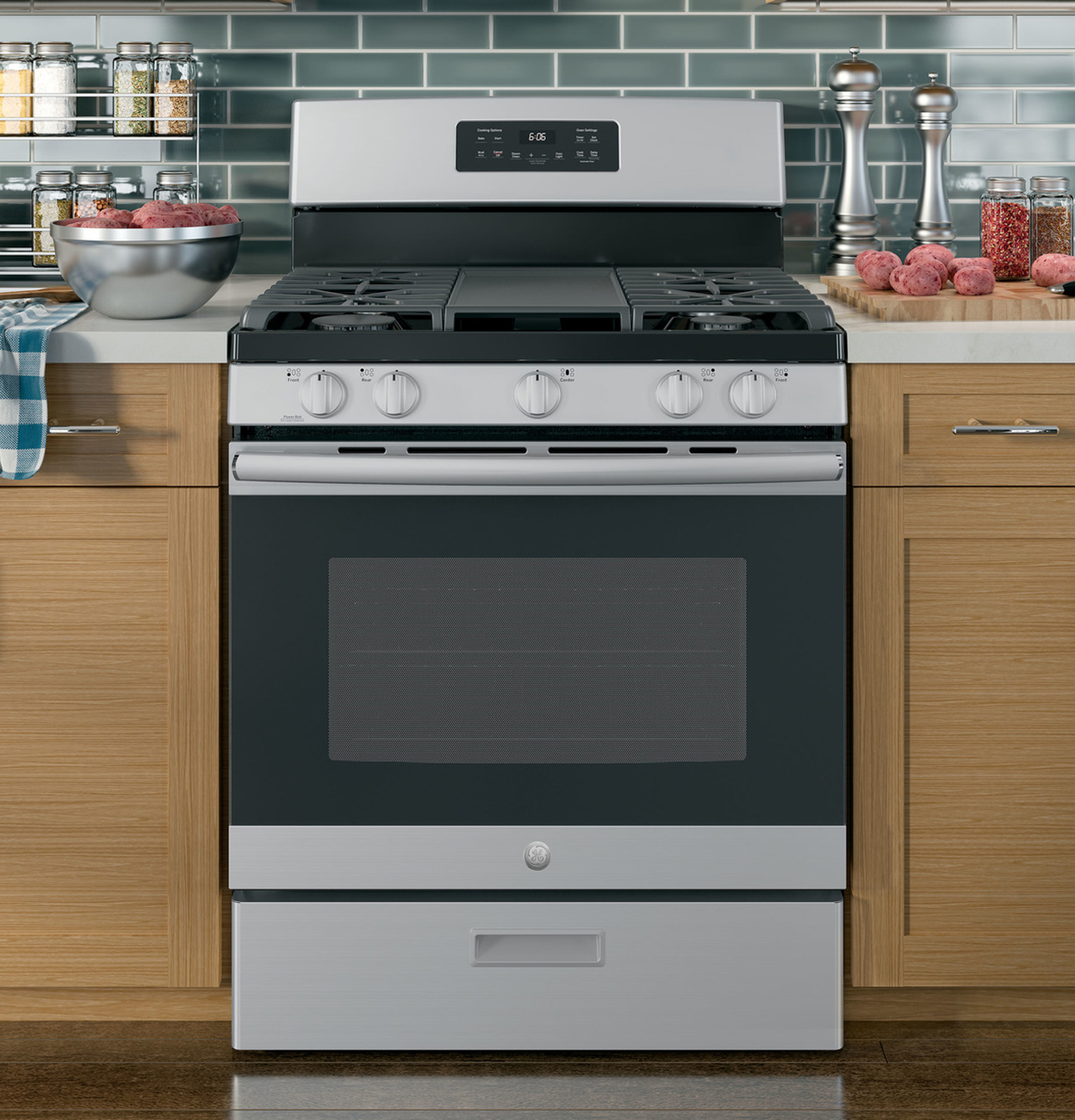 Gas range in between two kitchen cabinets.