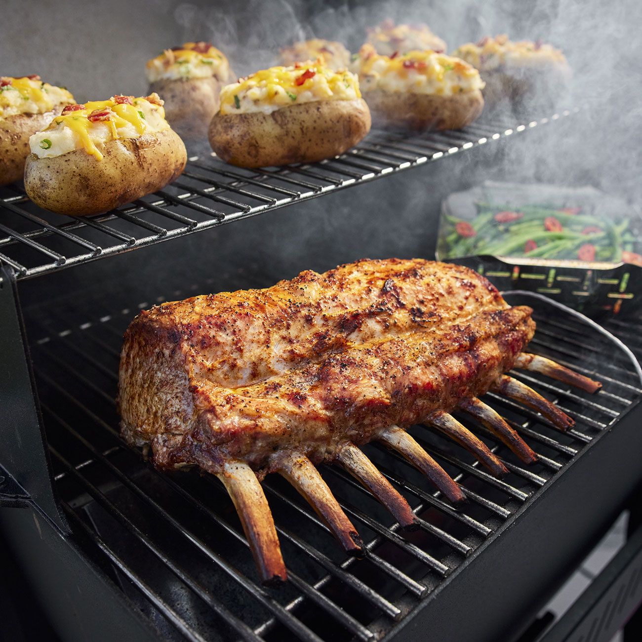 Lifestyle View of Weber Searwood 600 Pellet Grill Cooking Food