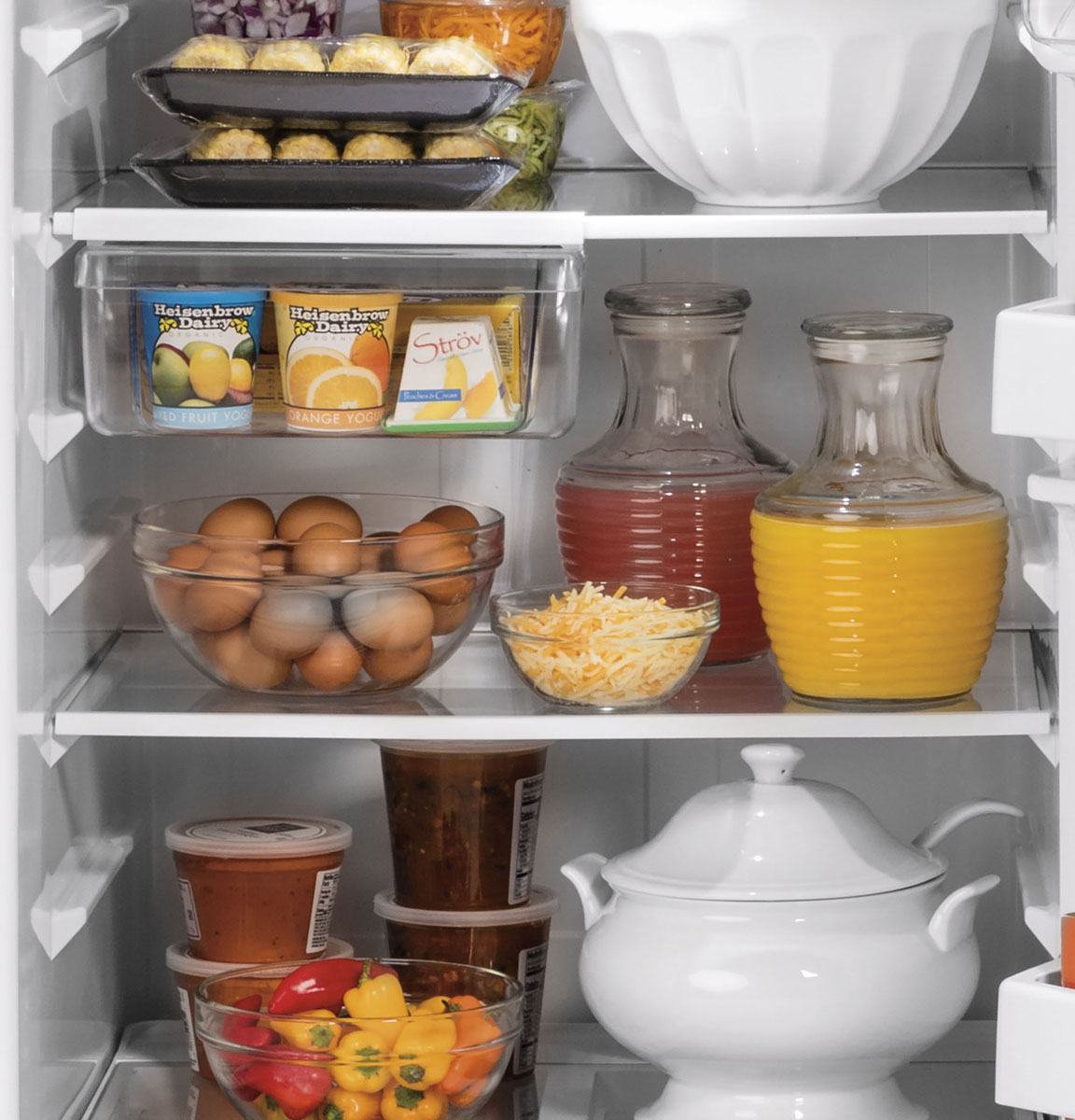 Front view of various foods and drinks on the shelves.
