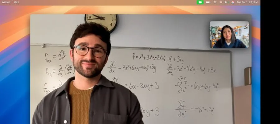 A man in front of a whiteboard on a video call. Center Stage keeps the camera focused on him as he moves