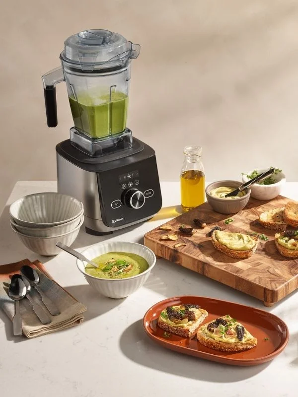 Vitamix Blender with soup in the container and food around the countertop showcasing how versitile you can be with a vitamix on appetizeres