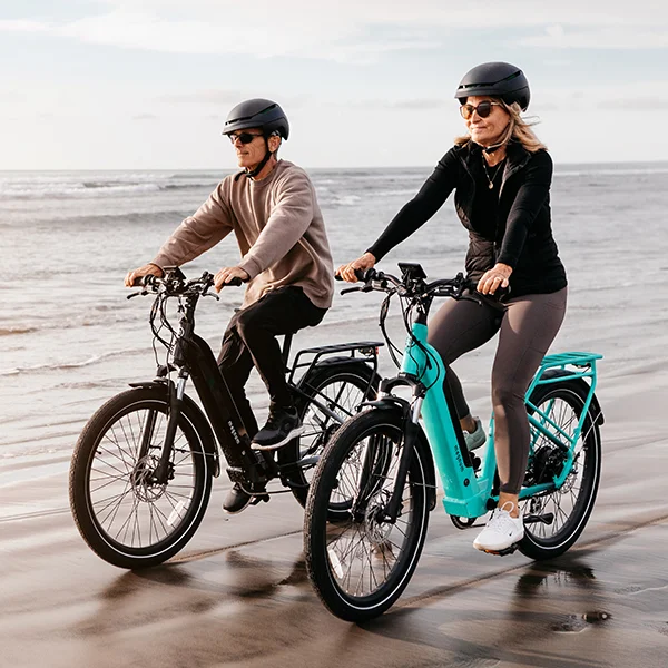 Two people riding Magnum electric bikes on the back