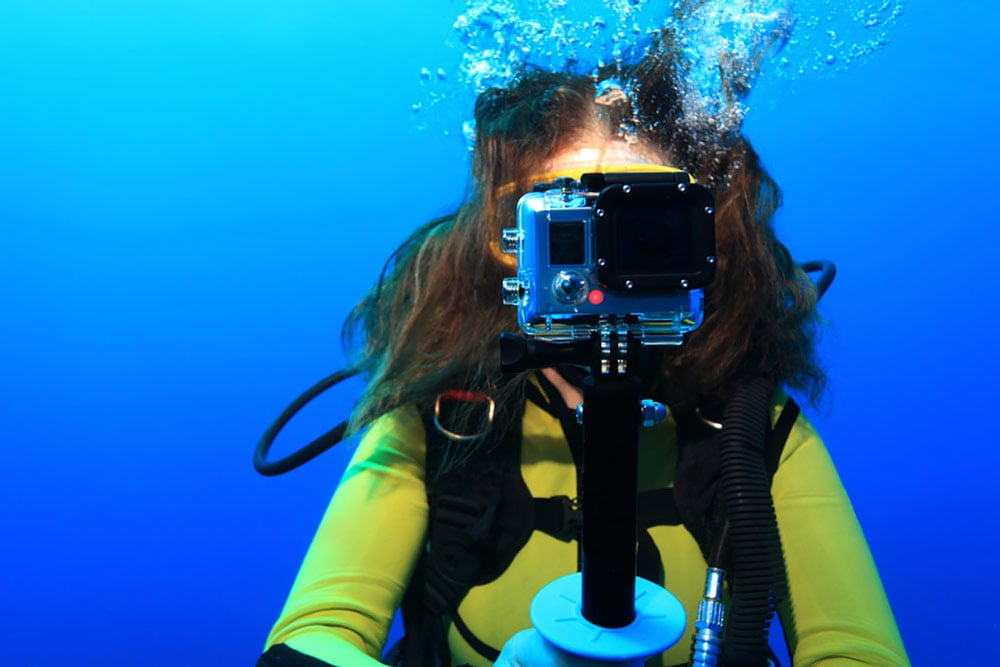 Person using action camera underwater