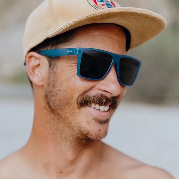 A man wearing a hat and a pair of Zeal Optics sunglasses