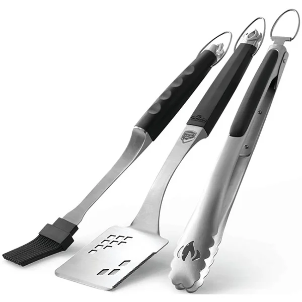 A stainless steel basting brush, spatula and tongs