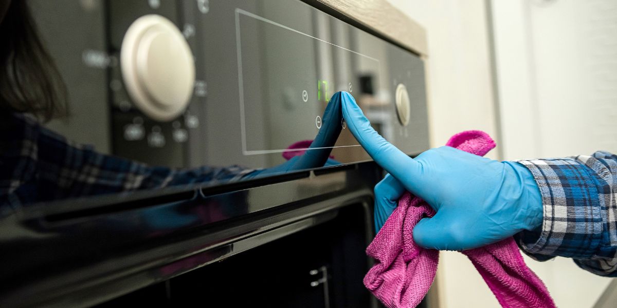 person wearing rubber gloves holding a microfiber cloth