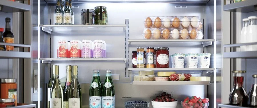 The Thermador T48BT110NS refrigerator from the inside with bright lighting and multiple glass shelves