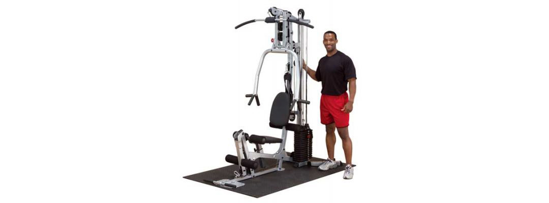Man Standing Next to Exercise Machine